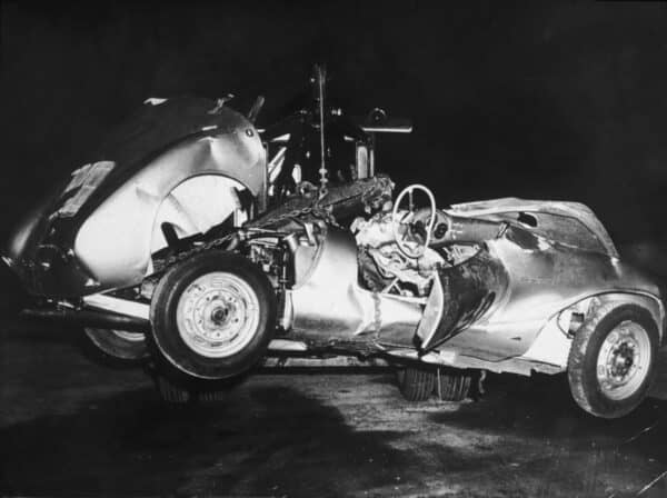 1955: The mangled remains of 'Little Bastard,' James Dean's Porsche Spyder sports car in which he died during a high-speed car crash, being towed by a tow truck, California. (Photo by Hulton Archive/Getty Images)